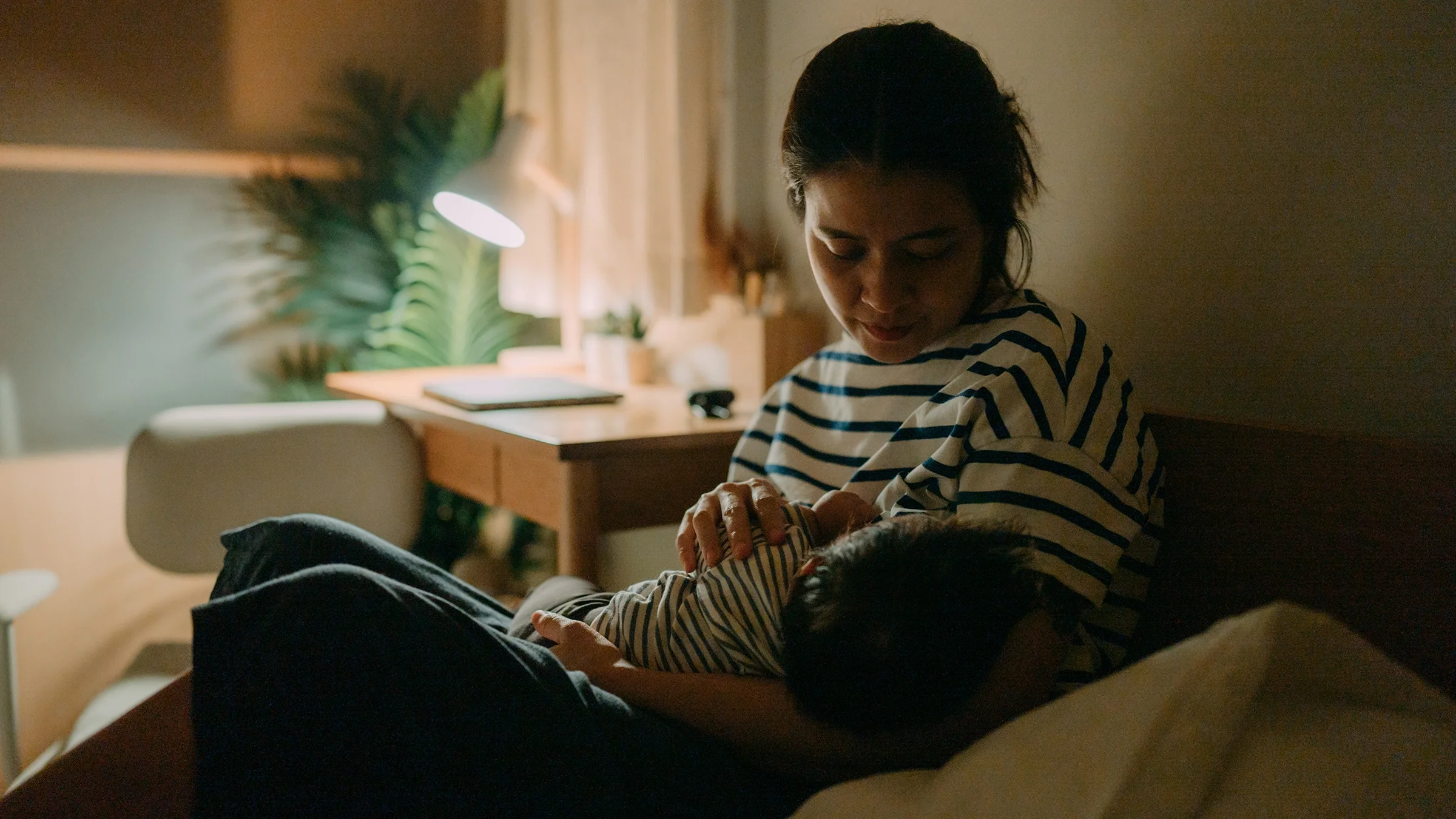 Parent nursing baby at home.