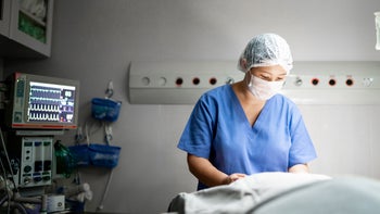 Health: Fertility: surgeon prepping in operating room-1318323724