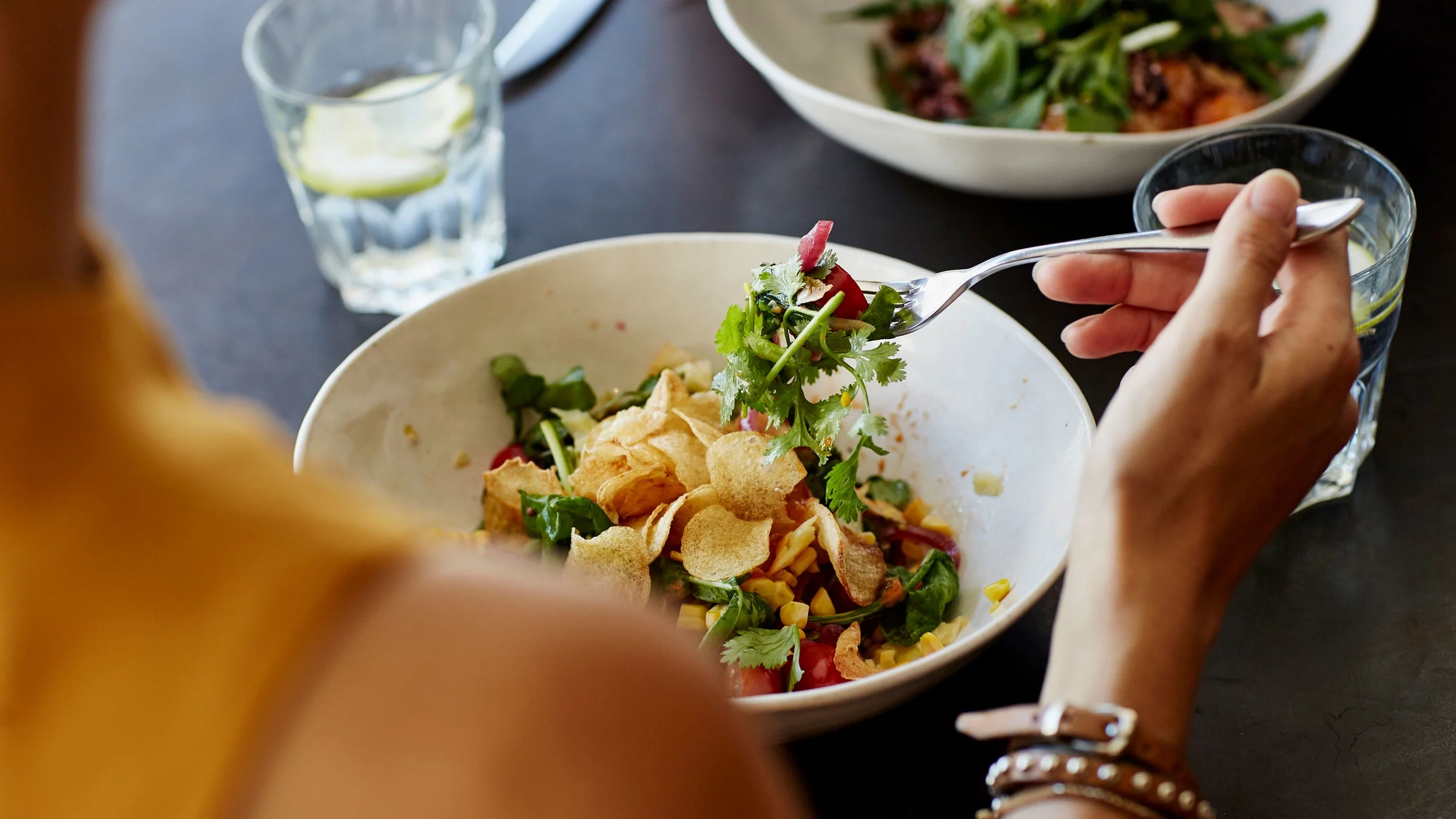 Close-up woman eating salad.