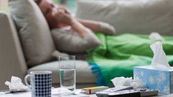 Health: Covid-19: woman sick on couch tissues 171631871