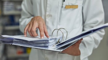 Pharmacists: pass inspection: pharmacist holding a binder 1059620100
