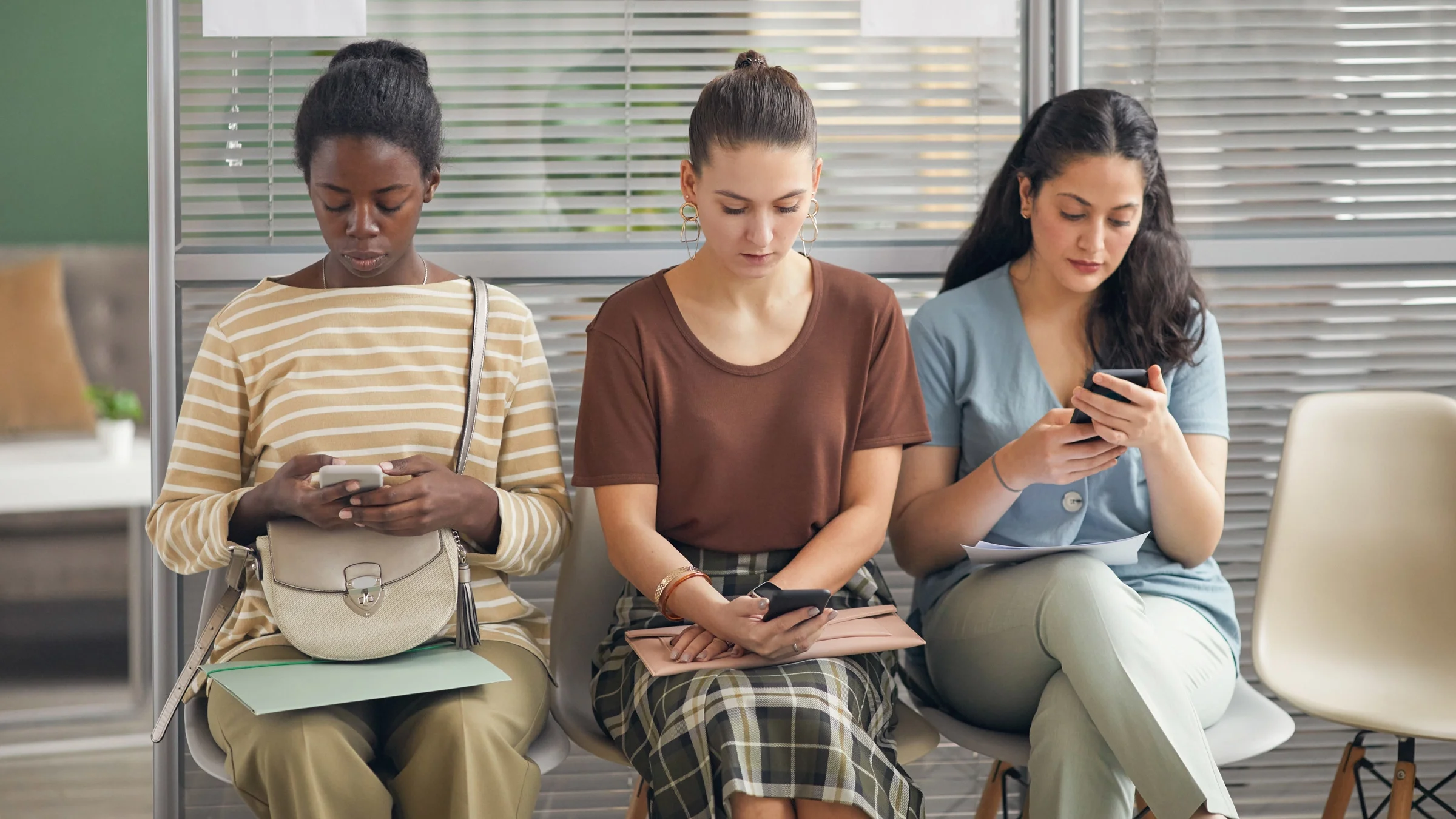 Women sitting in a waiting room. 