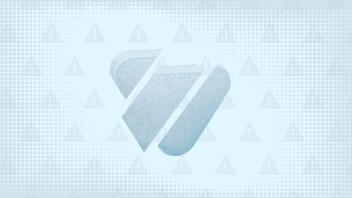 A graphic includes a light-blue background with a warning-sign pattern and a blue triangular pill cut into thirds. 