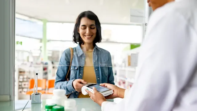 Progesterone: woman paying at pharmacy 1778307433