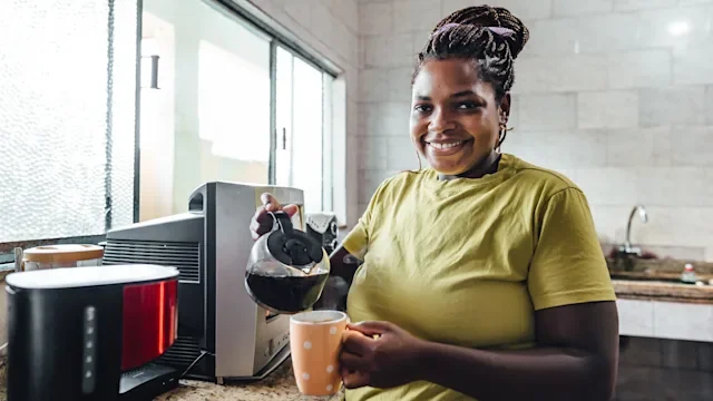 Diet Nutrition: woman pouring brewed coffee 2051796256