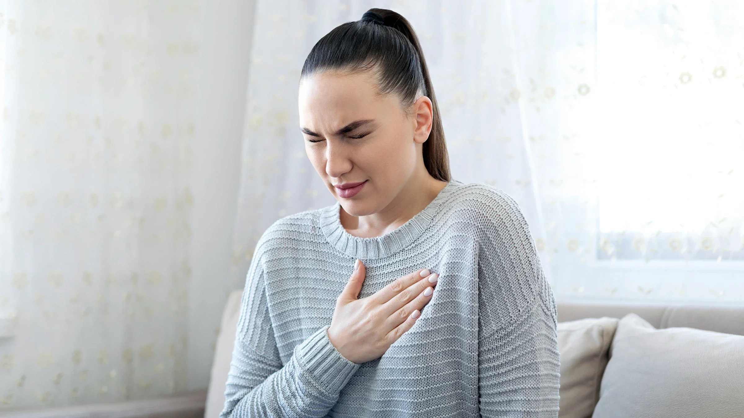 A woman struggles with heartburn.
bymuratdeniz/iStock via Getty Images Plus     