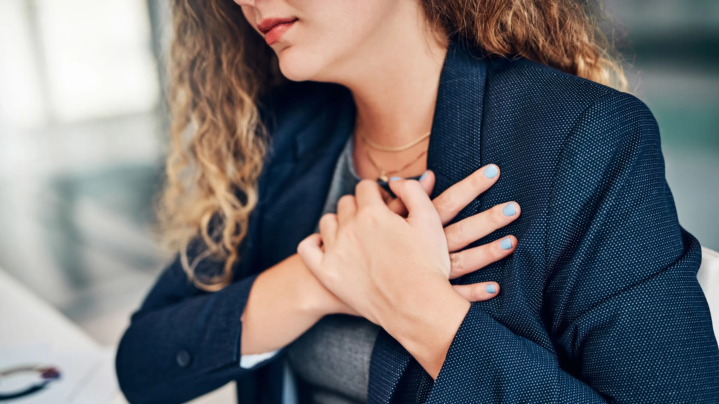 A cropped shot of a businesswoman with chest pain.