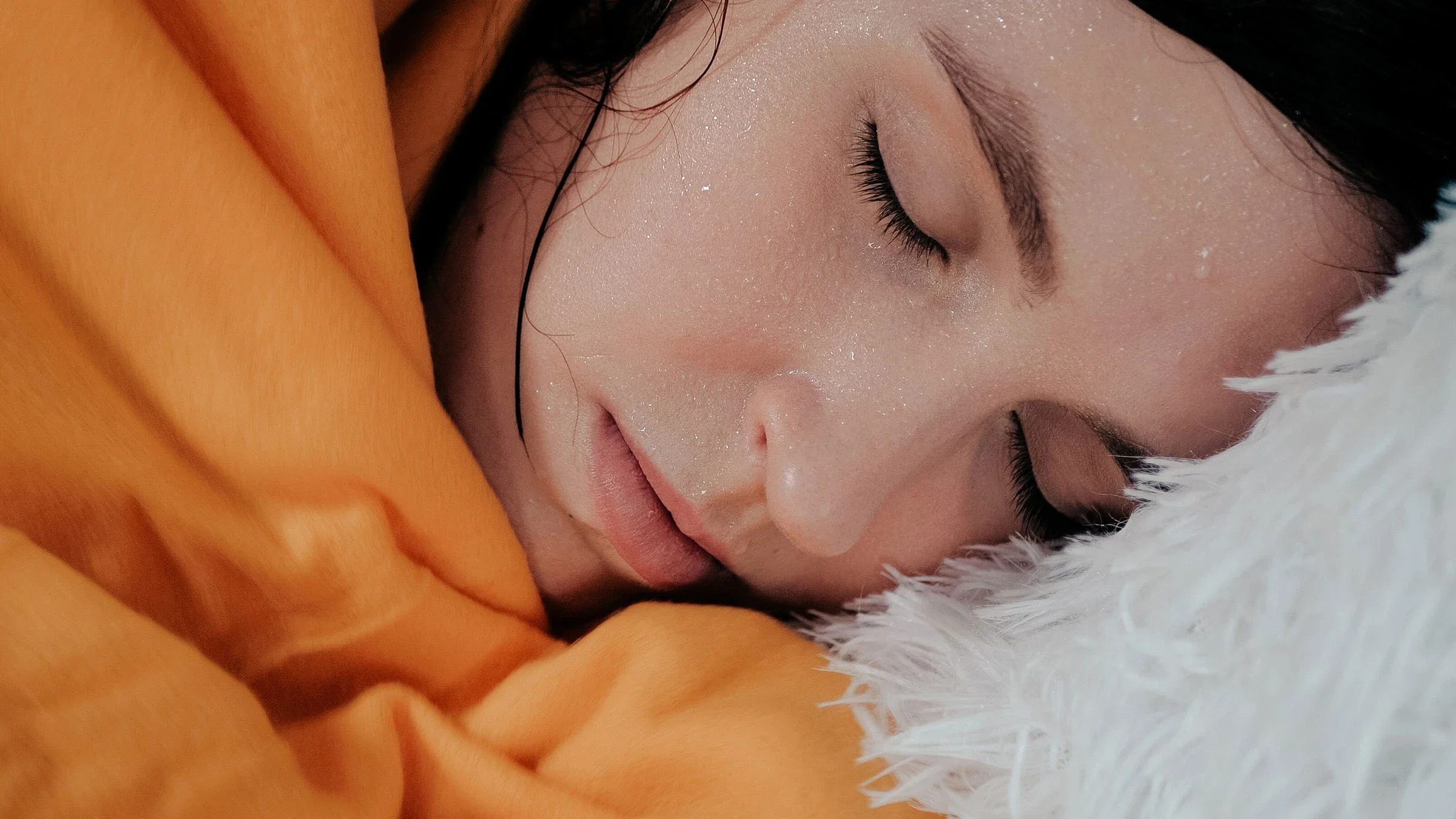 A woman is sweating in bed.
Stanislav Shkoborev/Getty Images