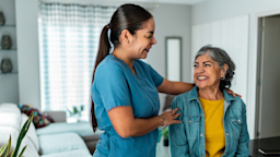 A home caregiver talks to an older woman at home.
FG Trade Latin/E+ via Getty Images