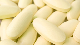 A close-up of a pile of oblong yellow pills.
lovelypeace/iStock via Getty Images
