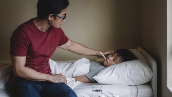 Health: Childrens health: father checking sons temperature 1297933345