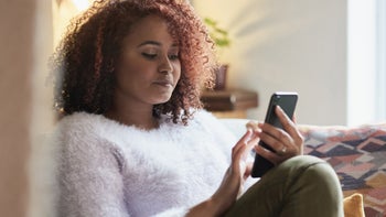 Progesterone: Fertility: woman on mobile phone at home-1303789694