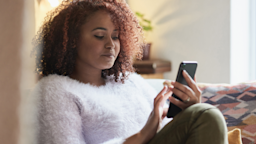 A young woman is on her cell phone at home.
Adene Sanchez/E+ via Getty Images
