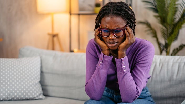 A woman suffers a migraine.