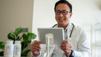 Health: Digital health: doctor using tablet for telehealth visit 1321545611