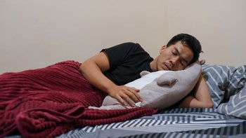 sleep: man sleeping and hugging pillow 2156446568