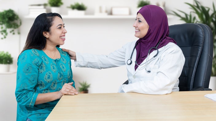 A gynecologist and patient having a conversation.