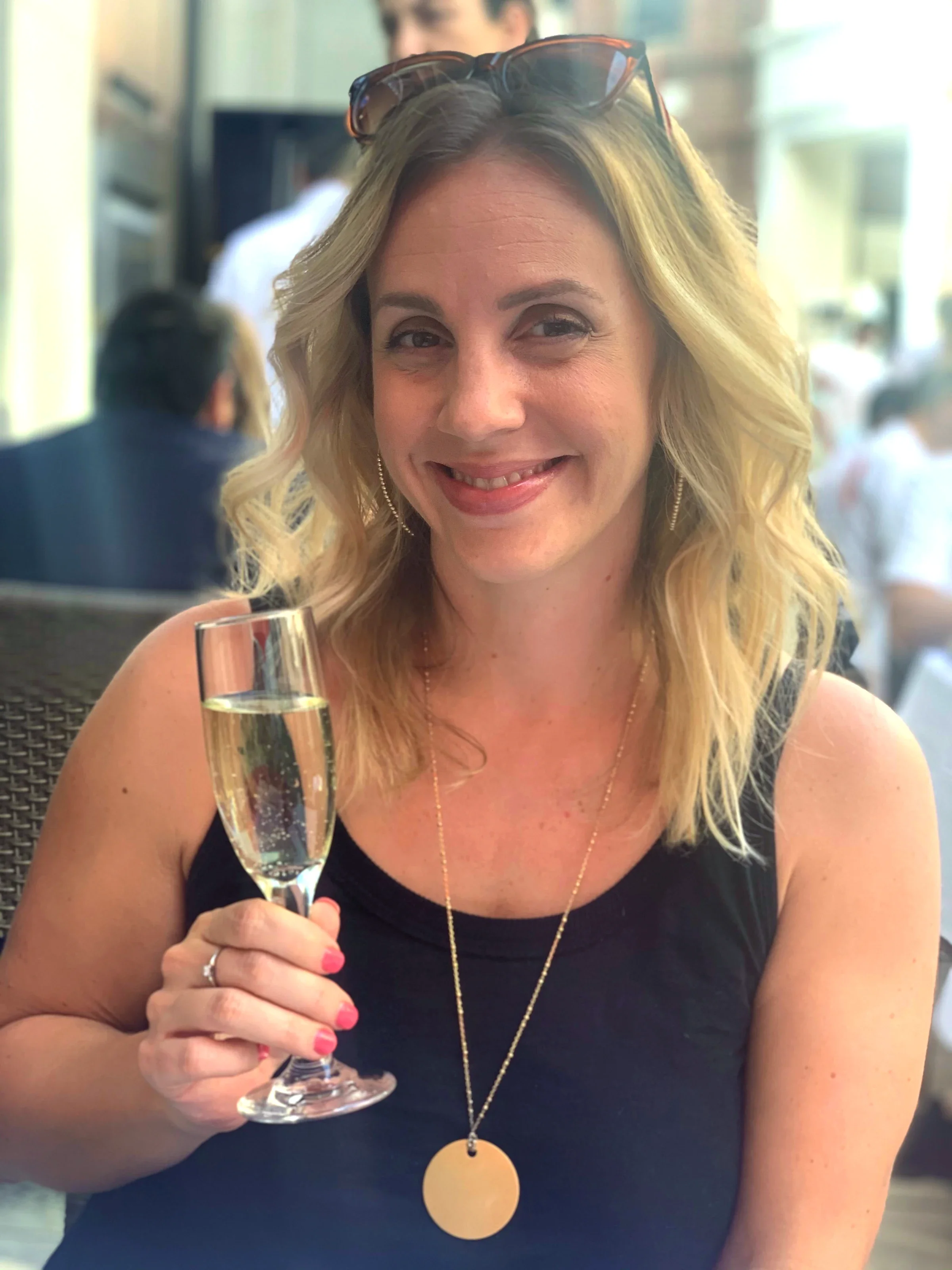 Colleen Oakley is pictured in a snapshot holding a champagne glass.