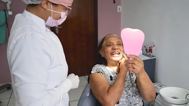 Dental care: senior woman at dentist 1350000300