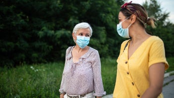 Vaccine: Hesitancy: masked conversation outside 1264500902