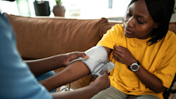 A person is checking their blood pressure at home.
da-kuk/E+ via Getty Images
