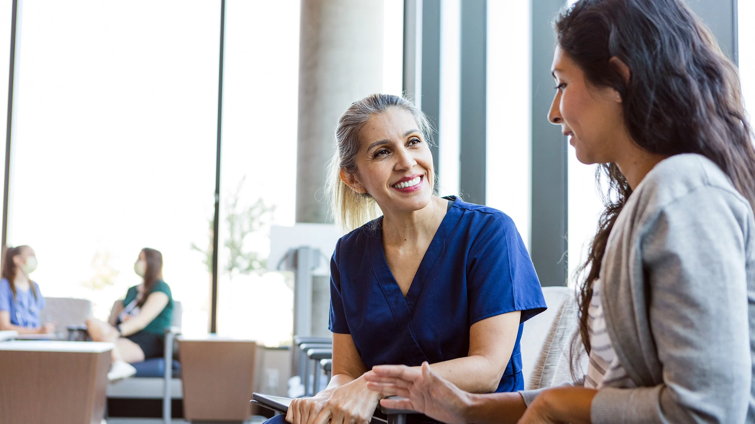 A medical professional speaks to a patient.