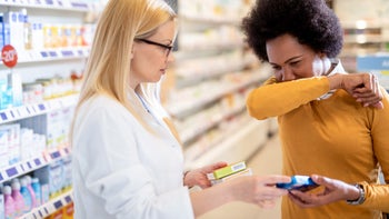 Cough: pharmacist helping patient with medicine 1277449324