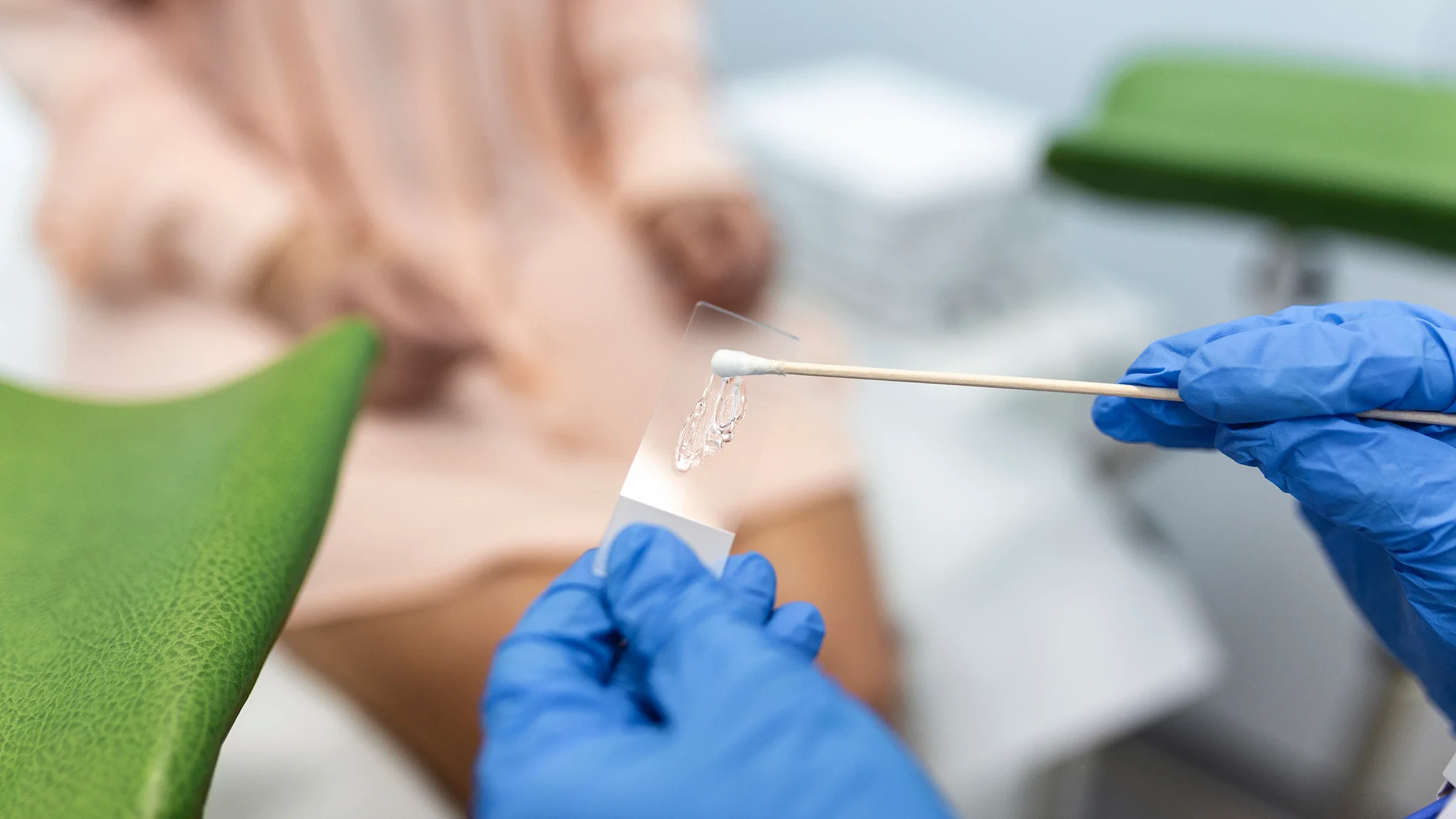 A close-up on a swab in a provider’s hands. They’re prepping for a Pap smear.
stefanamer/iStock via Getty Images
