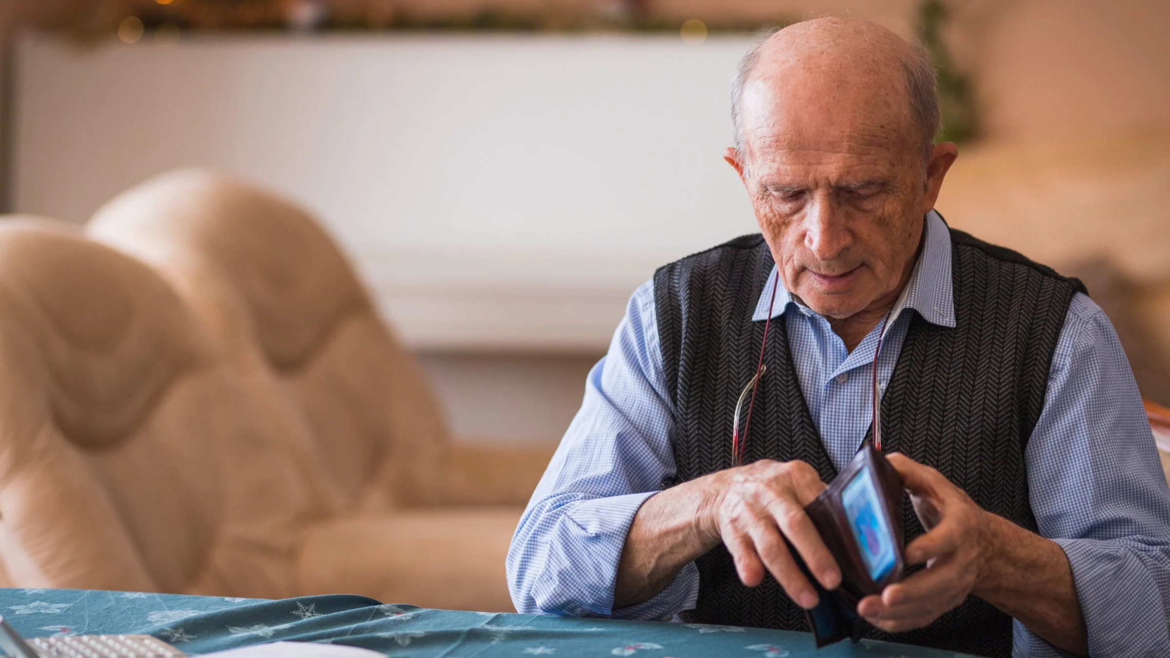 A person opening their wallet and counting money.