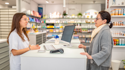 A woman is having a conversation with a pharmacist at the pharmacy counter.
Eloi_Omella/E+ via Getty Images