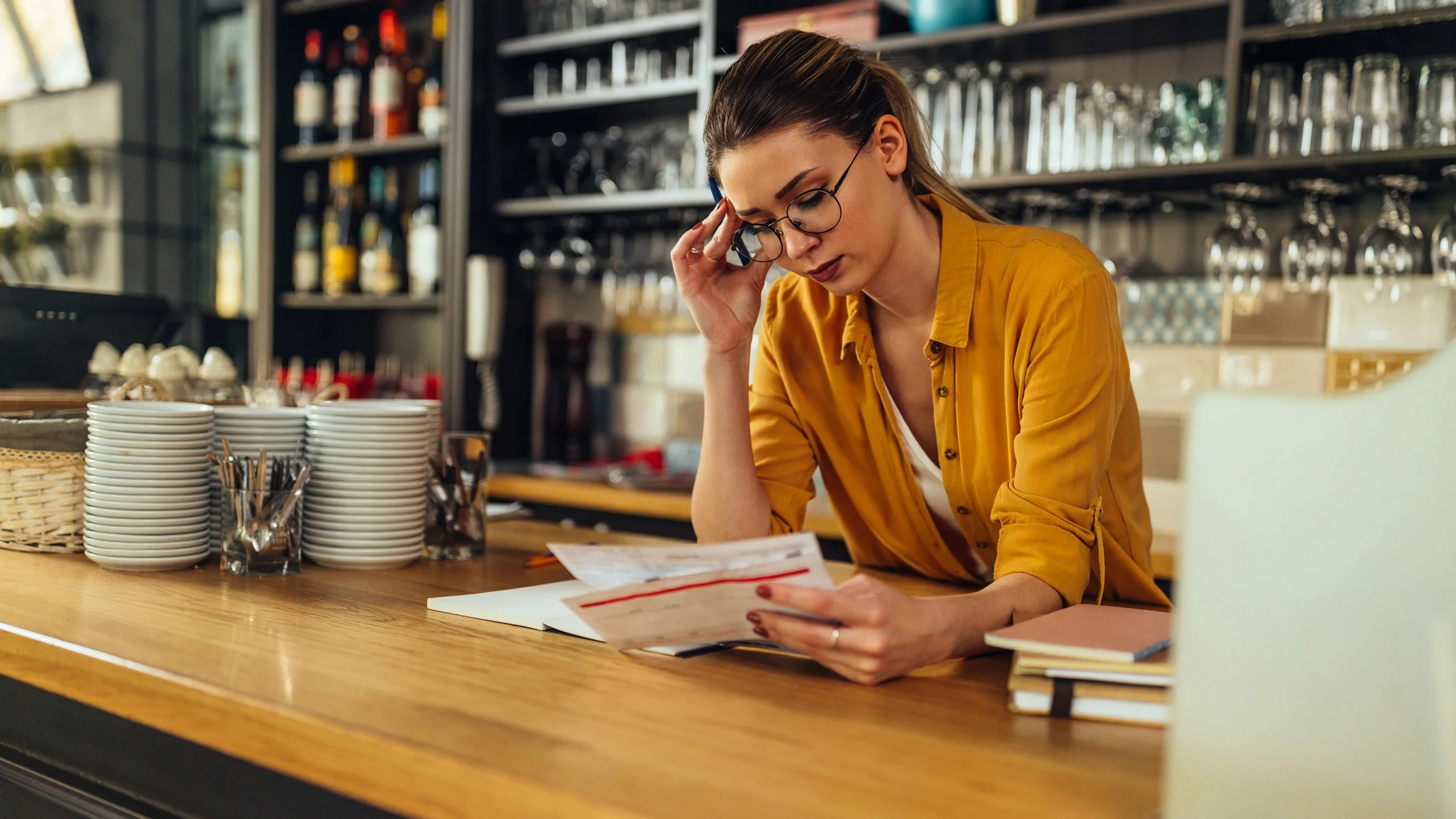 A restaurant owner calculating expenses.