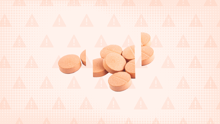 A graphic on Suboxone side effects has an orange background with warning signs and a pile of pills cut into thirds.  