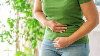 Women's Health: closeup woman holding stomach 2174676640