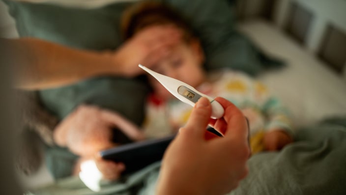Close-up thermometer taking child's temperature.