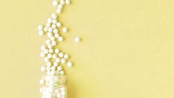 homeopathic pills yellow background 1157355819