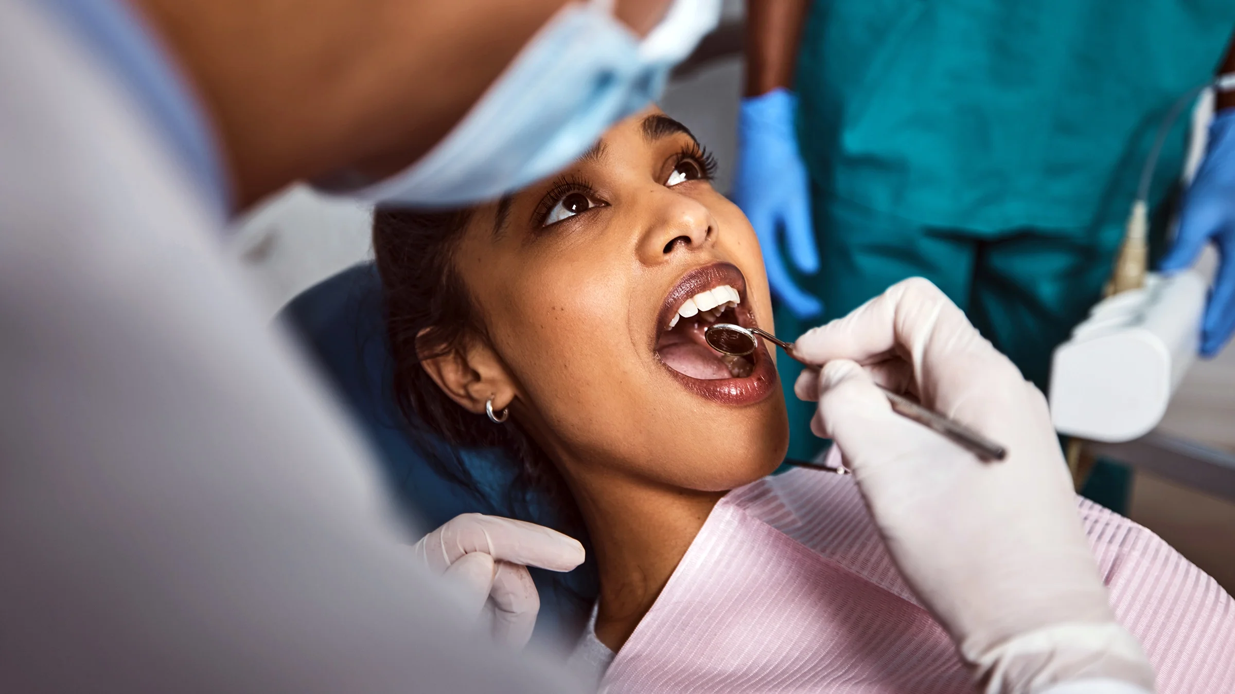 A woman receives dental treatment. The bacteria that cause cavities, a common tooth affection, can be transmitted from person to person through sharing utensils and kissing.