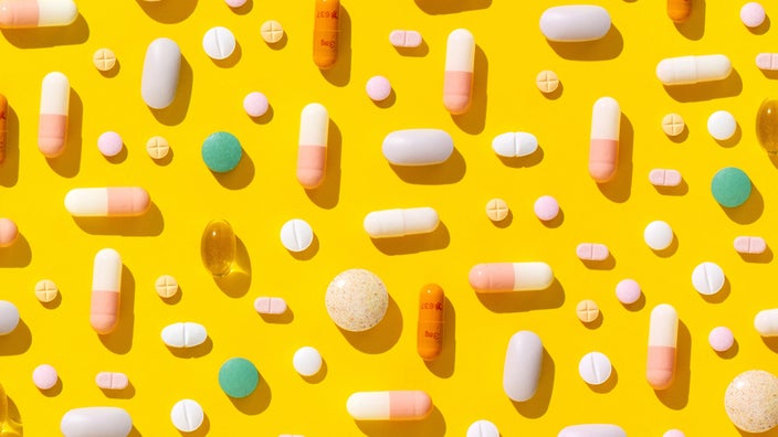 Colorful pills on a yellow background.