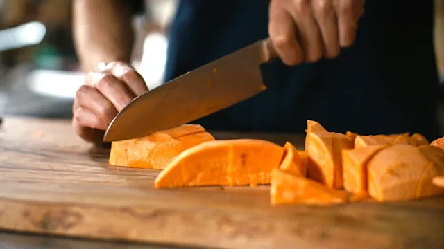 diet-nutrition: closeup slicing sweet potato 2281999646