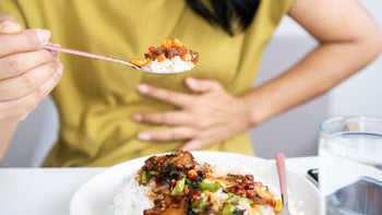Esomeprazole: Generic: close up food woman with heartburn GettyImages 1325738642