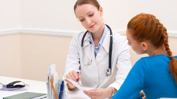 fungal infection: doctor explaining prescription pad 134458981