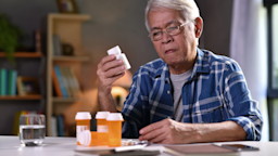 Old man reviewing his medications at the dining table.
amenic181/iStock via Getty Images

