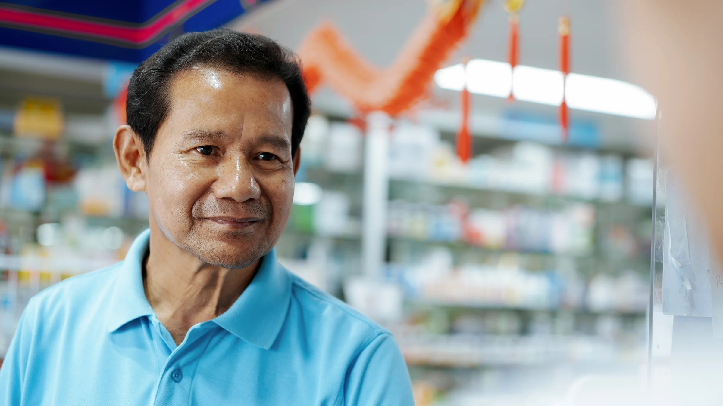 Senior man speaking to pharmacist