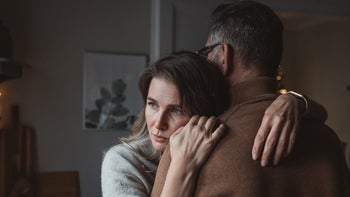 Relationships: couple embrace at home 1350729633