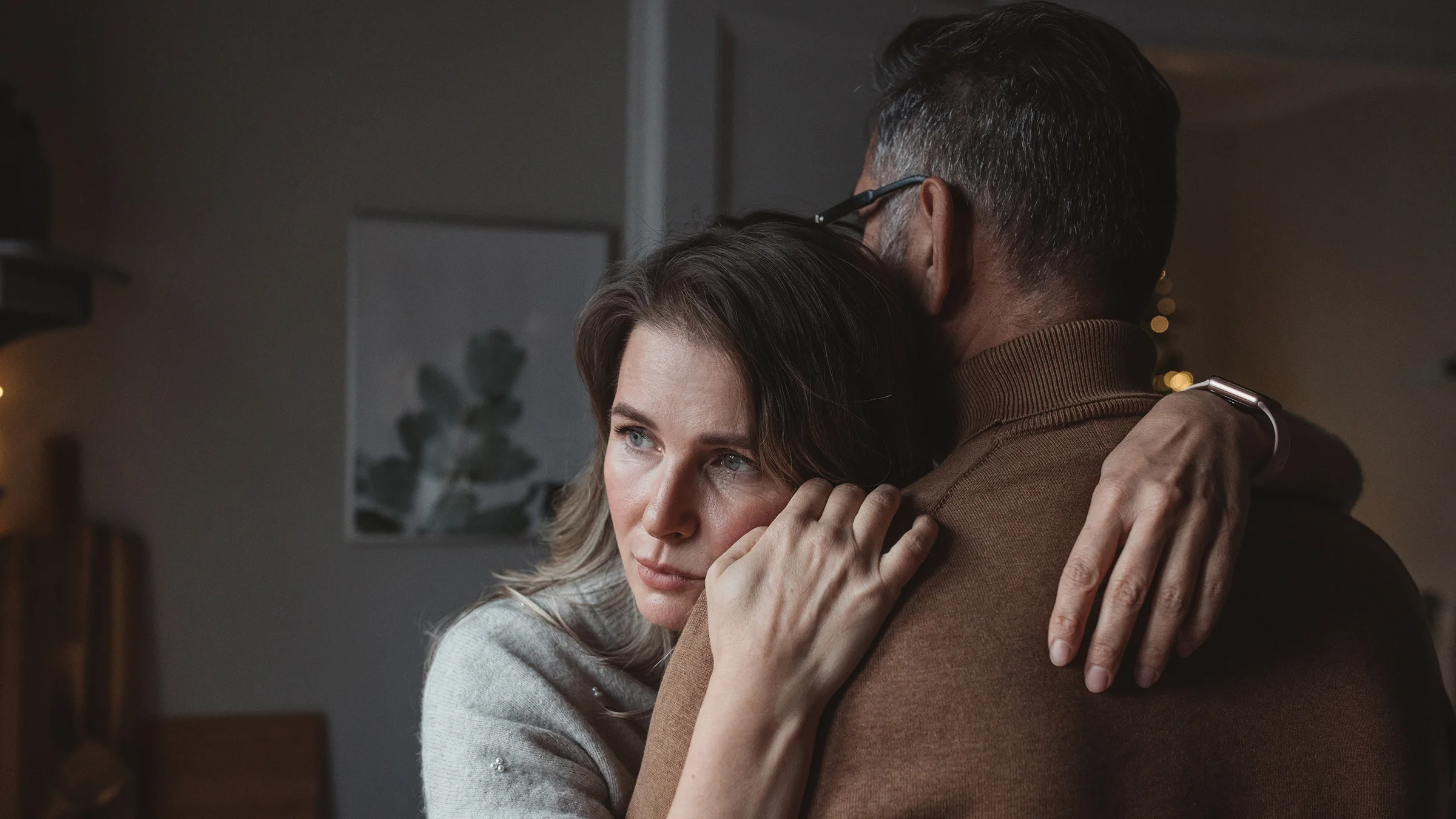 Couple embrace at home