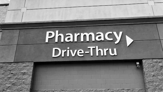 Health: HCP: drive thru pharmacy sign on building-1004656974