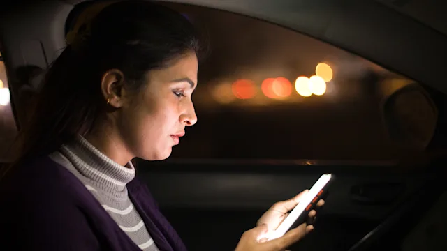 Relationships: woman using phone in car 1298658723