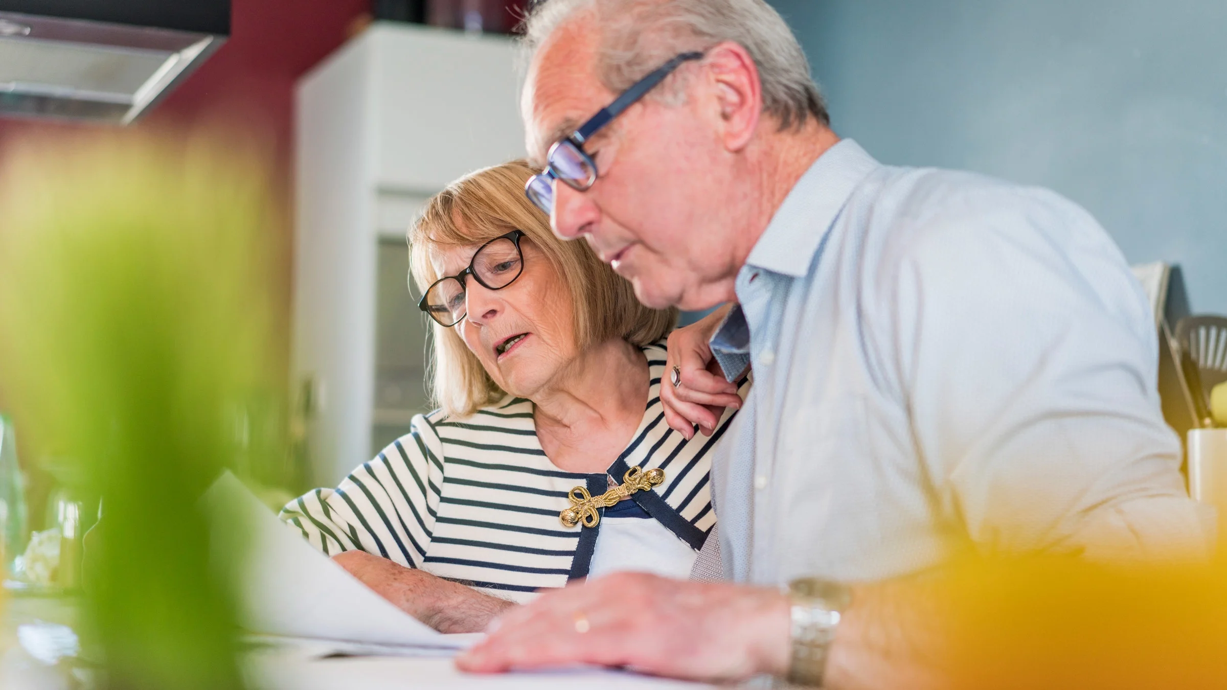 An older couple looking at their bills.