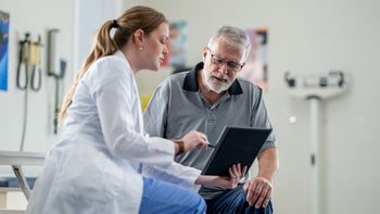 high-cholesterol: healthcare professional speaks to patient 2048635835