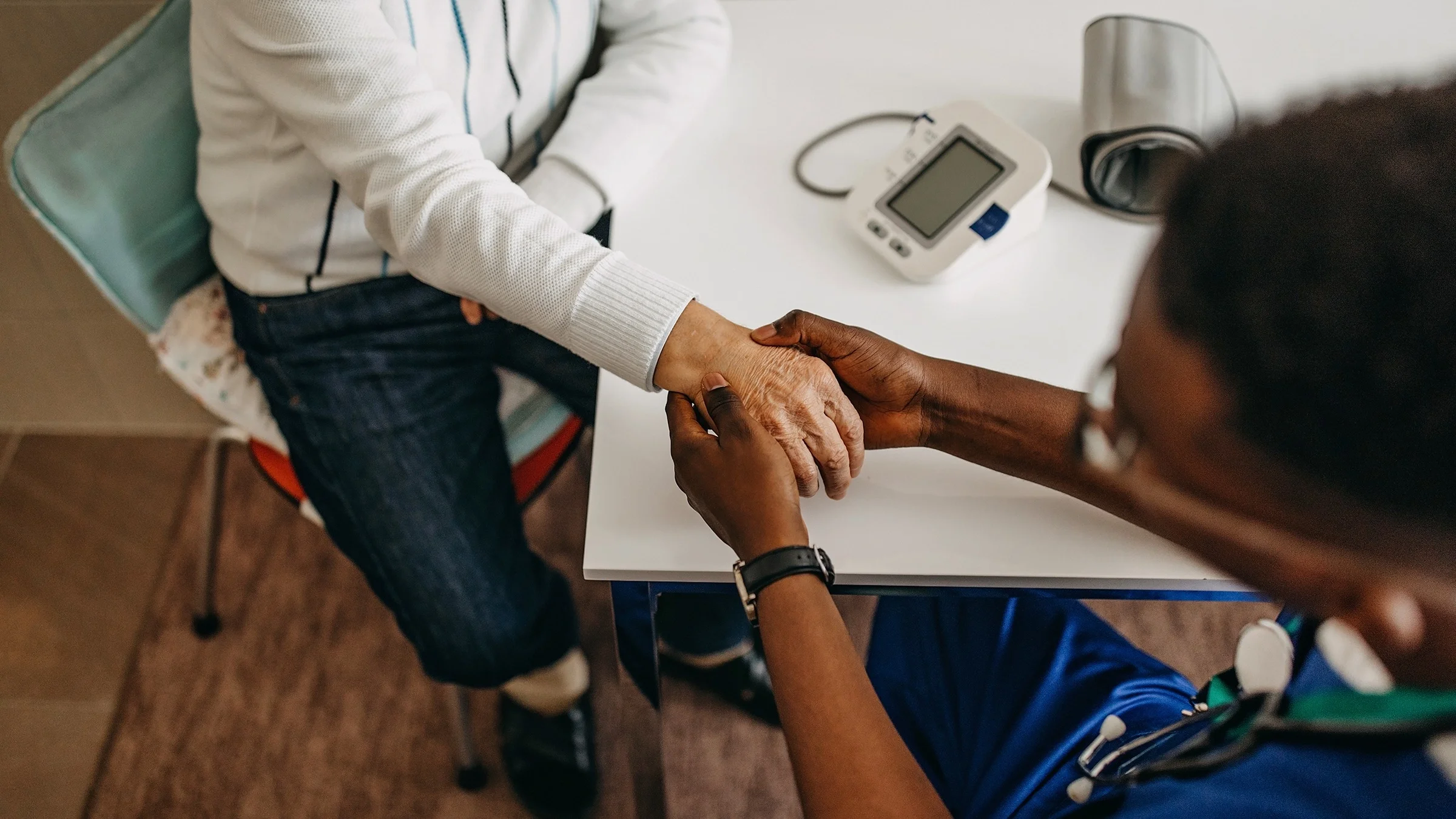 Close-up on a senior man's hand as his doctor is checking his wrist for arthritis.