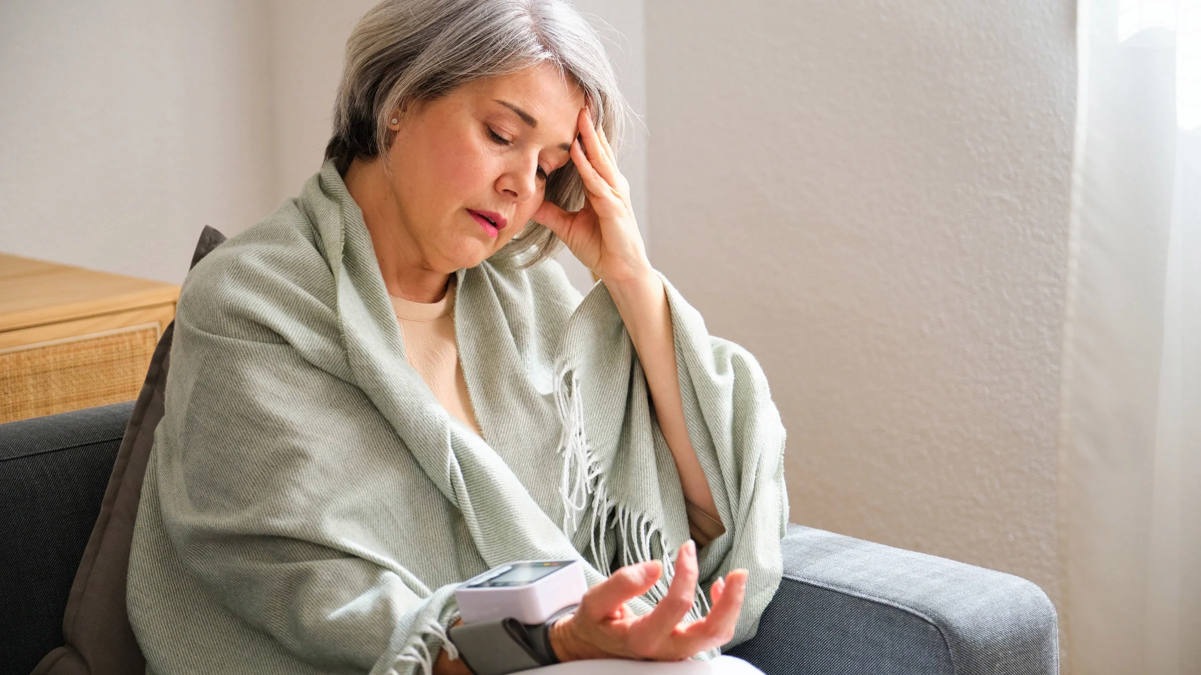 A stressed out person checking their blood pressure.
